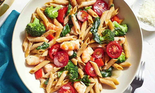 Penne Primavera prepared with fresh vegetables and warm tomato sauce