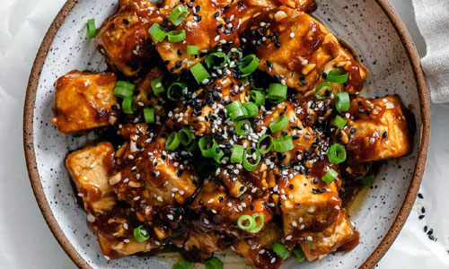 Sesame Tofu glazed with sweet soy sauce and sesame seeds